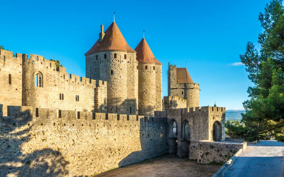 The Narbonne Gate towers of the Cité de Carcassonne under a blue sky